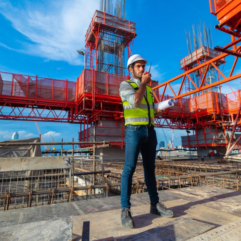 Portrait of an engineer designing a large project inspecting the job site to meet specifications.